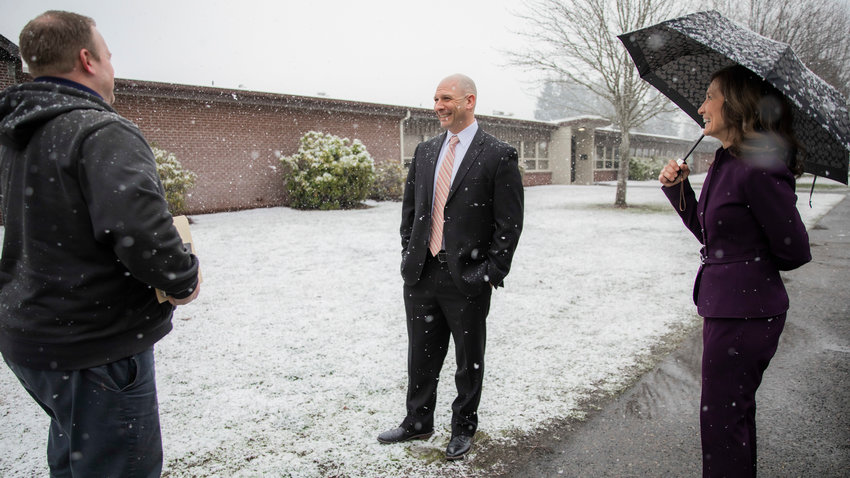 Superintendent Dr. Lisa Grant, far right, and Director of Facilities and Maintenance Eric Wilson, far left, talk with State Rep. Peter Abbarno about improvements at Oakview Elementary School on Wednesday in Centralia as snow falls.