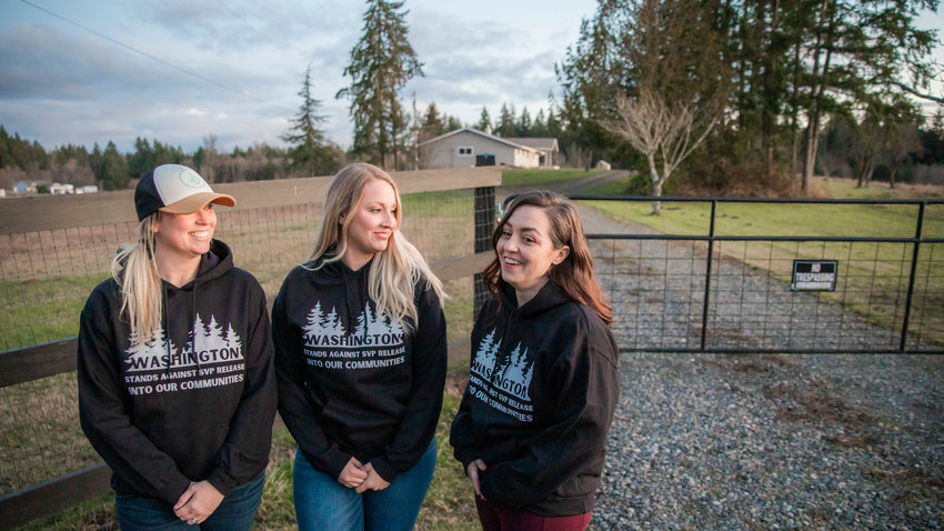 Sarah Fox, Kendahl Tuttle and Kerri Jeter smile and gather outside a residence located at 2813 140th Ave. SW near Tenino Tuesday to discuss an announcement from Supreme Living that it will not proceed with providing supportive housing services for sex offenders at its property.