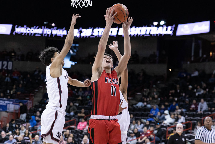 Mossyrock guard Zack Munoz throws up a shot against Lummi Nation in the 1B state tournament round of 12 at Spokane Arena March 1.