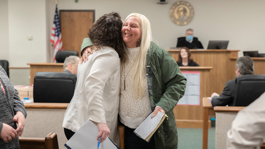 Charlotte Sharon Norton hugs Mental Health Court Program Coordinator Sophia Limacher on Thursday in Lewis County Superior Court.
