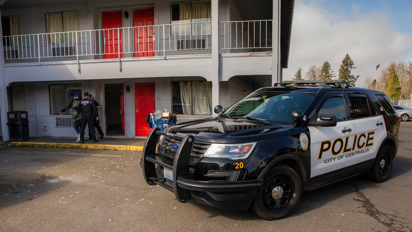 Law enforcement from the Centralia Police Department respond to the OYO Hotel after a woman locked herself inside the laundry facility with a knife on Thursday.