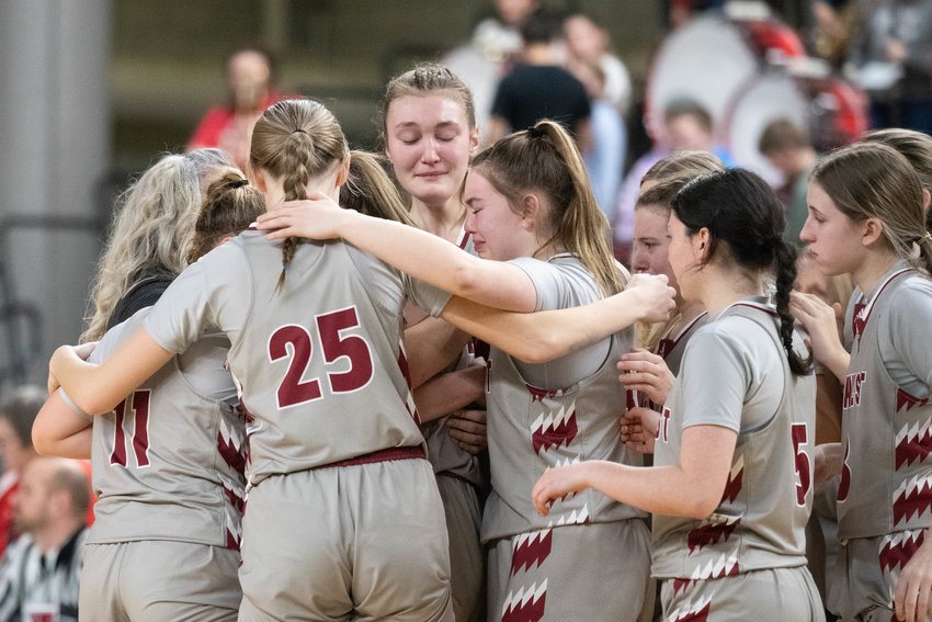 W.F. West players embrace after their 56-44 loss to Othello in a loser-out game at the 2A girls state basketball tournament, March 3 in Yakima