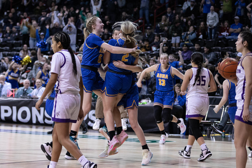 The Adna girls basketball team celebrates after Danika Hallom's buzzer-beating layup helped the Pirates defeat Mabton, 50-48, in the 2B state consolation semifinals at Spokane Arena March 3.
