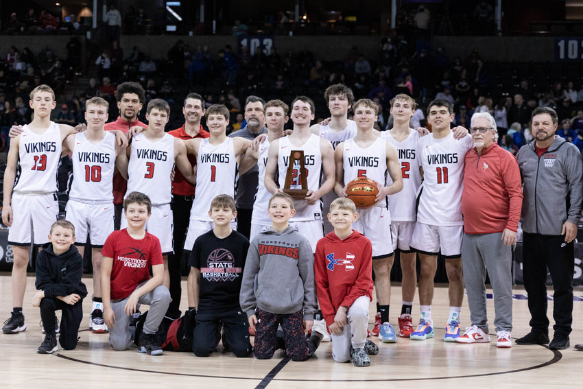 The Mossyrock boys basketball team poses with the 1B fourth-place trophy at Spokane Arena March 4.