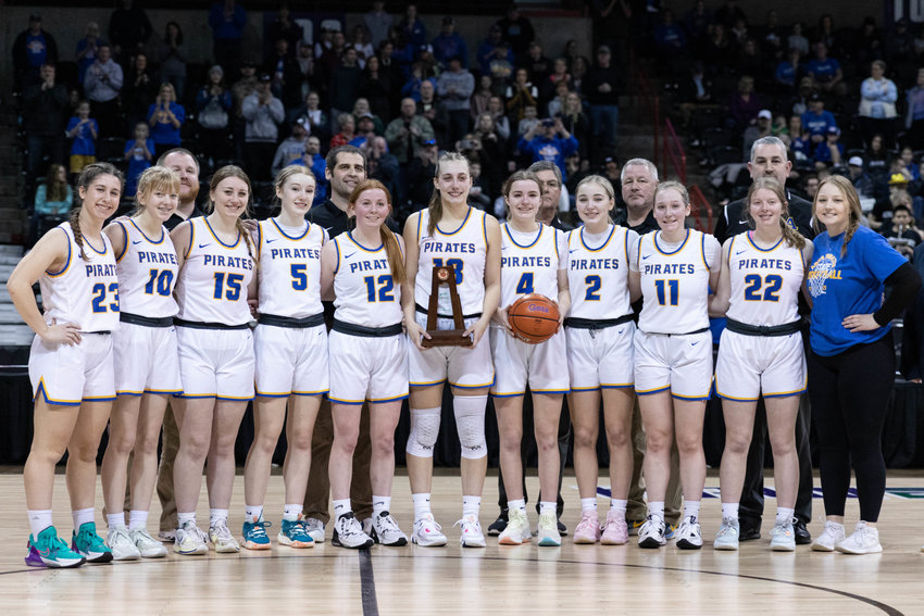 The Adna girls basketball team poses with the 2B sixth-place trophy at Spokane Arena March 4.