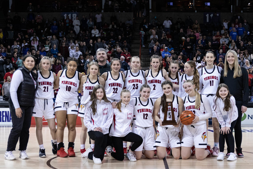 The Mossyrock girls basketball team poses with the 1B second-place trophy at Spokane Arena March 4.
