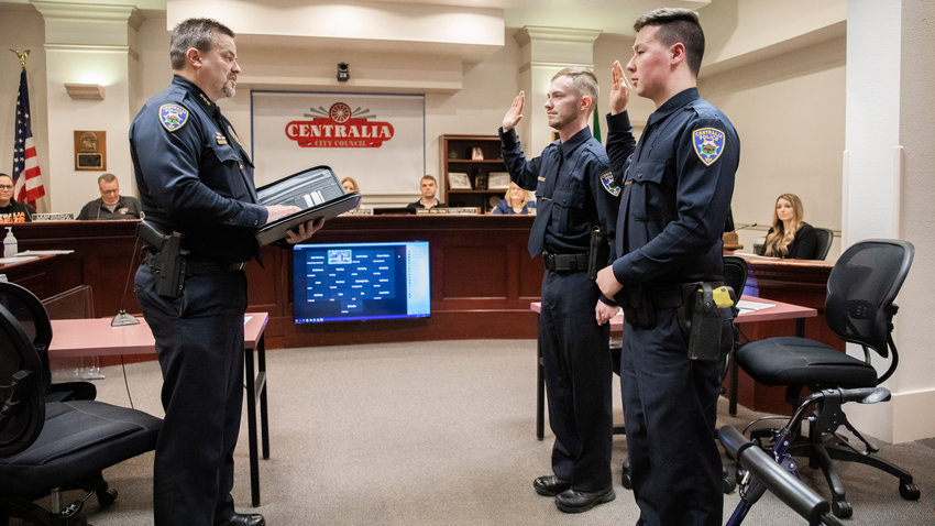 Centralia Police Chief Stacy Denham swears in two new officers, Colton Pruitt and Caleb Parsons, in front of the Centralia City Council on Tuesday.