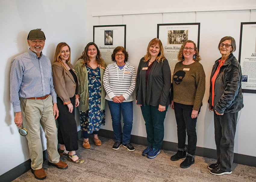 Members of the Ridgefield Heritage Society stand in front of a display highlighting pioneering women of the city at the Ridgefield Community Library. From left to right are Ken Spurlock, Kristen Riggs, Belle Mathieu, Linda Henick, Beth Boyle, and Janet Mashburn.