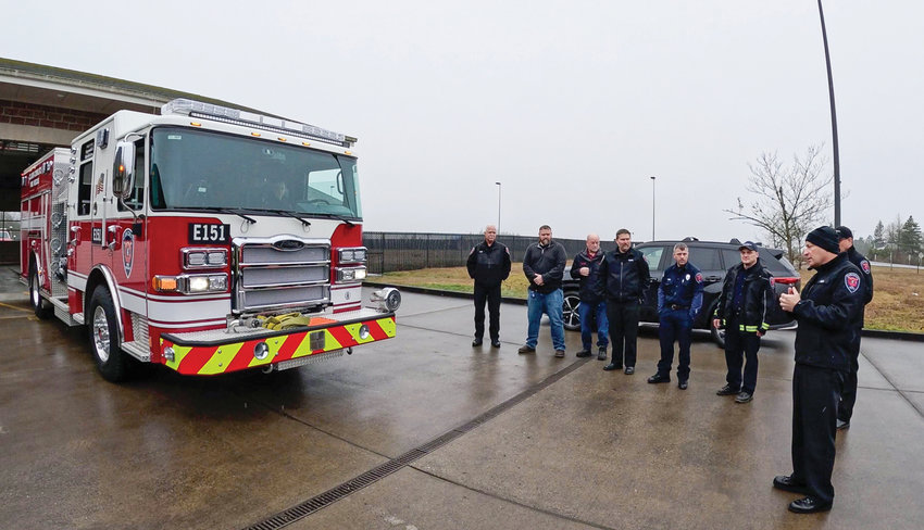 Clark-Cowlitz Fire Rescue Chief John Nohr, right, speaks to firefighters and fire commissioners prior to a &ldquo;push-in&rdquo; ceremony for a new fire engine at Station 151 on March 8.