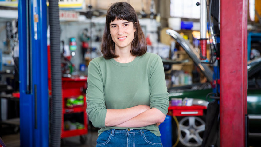 Marie Glusenkamp Perez smiles for a photo inside Dean's Car Care, INC. in Portland.