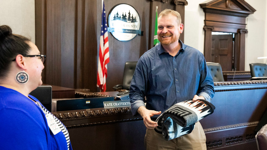 Erik Martin laughs as he receives a gift from Lewis County Public Health &amp; Social Services Director Meja Handlen with a message that reads, &ldquo;Erik, wash your hands &amp; don&rsquo;t be gross,&rdquo; Wednesday afternoon in Chehalis.