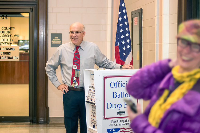 Lewis County Auditor Larry Grove stands at a ballot box inside the Lewis County Courthouse counting down the final seconds of voting in this 2017 Chronicle file photo.