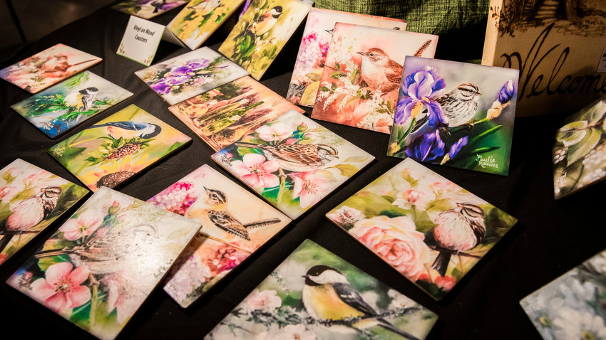 Paintings of birds by Paulie Rollins are illuminated during the Tenino Arts Spring Market featuring 32 regional artisans inside the Kodiak Room in 2023.