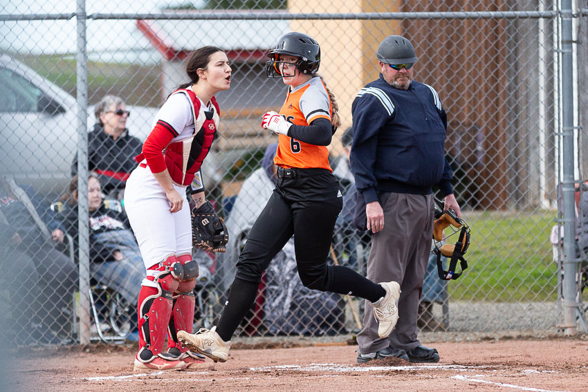 Centralia's Hollynn Wakefield touches home plate to score a run against Toledo March 27.