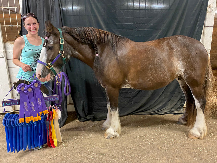 Kristina Lotz stands next to her 13.2-hand gypsy mare Merida the Bitless with the accolades the pair earned in 2022. Photo courtesy of Lotz.