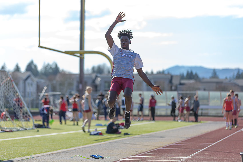 W.F. West's Brian Anouma leaps in the long jump at Tumwater District Stadium March 29.