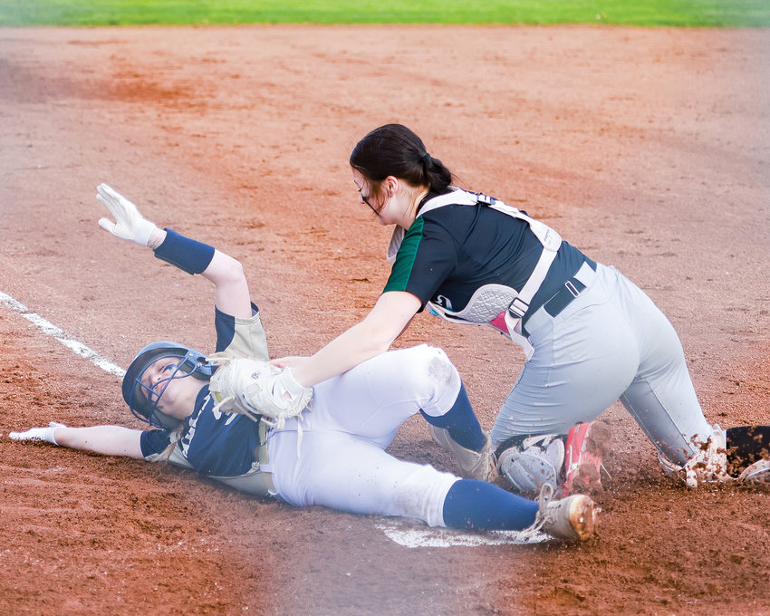 Catcher Ainsleigh Utter puts on a tag at home plate during Woodland's game against Kelso on Wednesday, March 29.