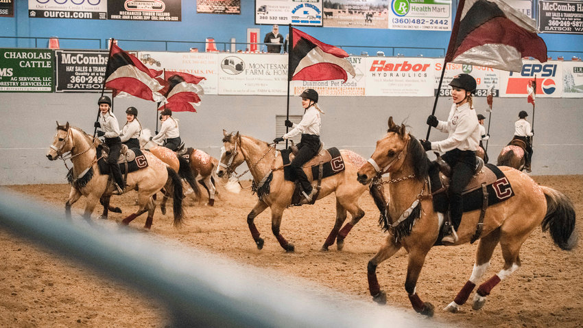 Riders on the W.F. West High School Equestrian Team make a sharp turn during a drill team event on Saturday night for a district meet at the Grays Harbor County Fairgrounds.