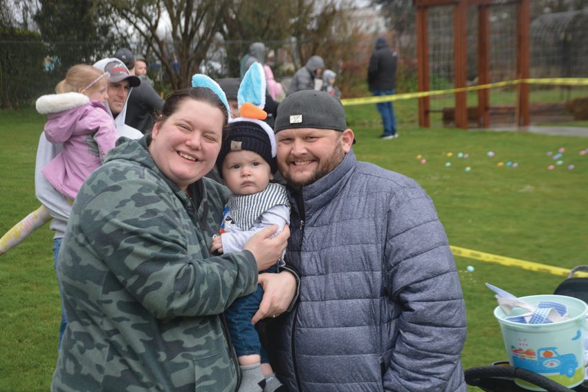 Kailie and Ricky Klitsch pose for a photo with their 9-month-old son Mason at Yelm City Park during an Easter egg hunt on Saturday, April 1.