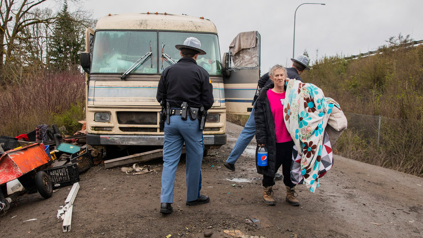 Residents grab their belongings out of travel trailers and RVs as crews from Grant&rsquo;s and JJ&rsquo;s Towing prepare to tow them from the end of Eckerson Road in Centralia on Thursday, April 6, 2023.