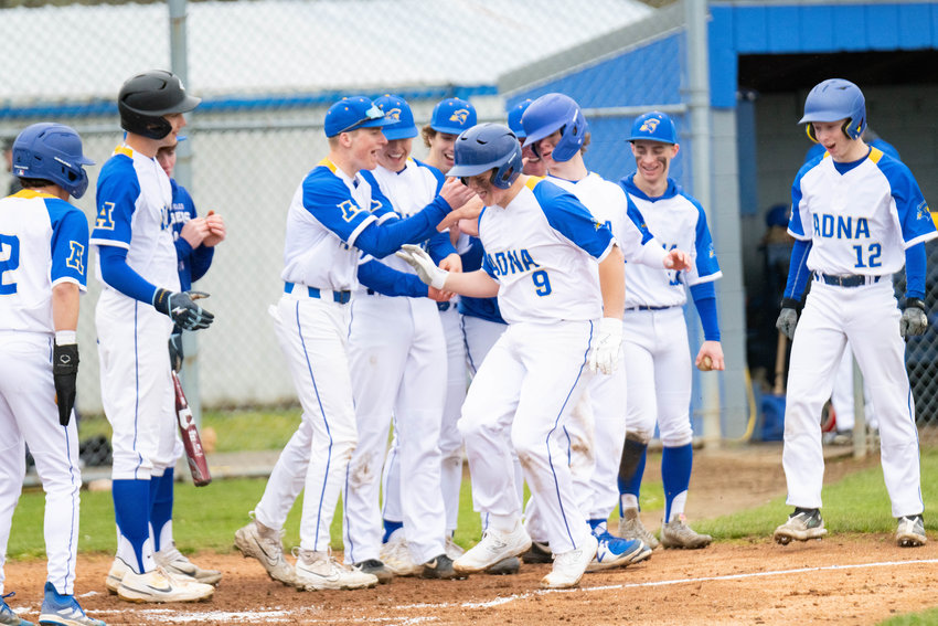 Sawyer Terry is welcomed back to the plate after his three-run shot in the third inning of Adna's 8-0 win over Ilwaco on April 8.