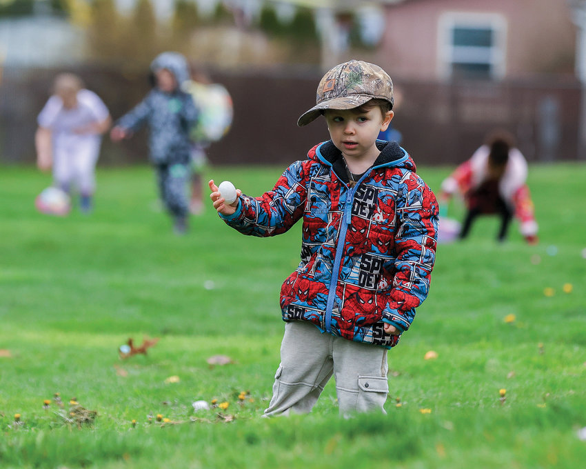 A kid finds an egg at Kiwanis Park in Battle Ground on Saturday, April 8.