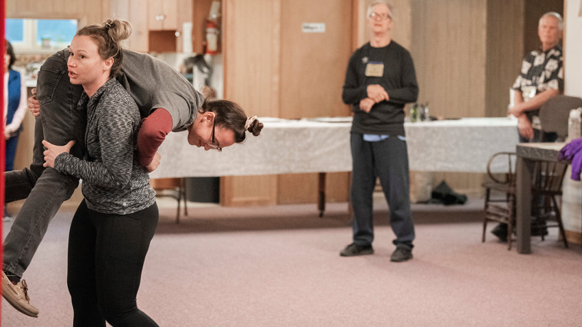 Crystal Garcia is picked up during a demonstration at a self defense class at the Toledo Presbyterian Church last month.