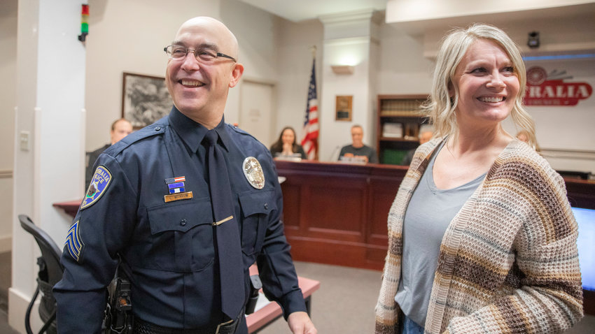 Sergeant Chad Withrow smiles after his wife Brianna pinned on his badge during a city council meeting on Tuesday, April 12, 2023.