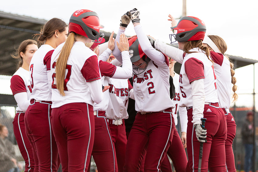 W.F. West's dugout surrounds Saige Brindle (2) after her home run against Rochester at Rec Park April 12.