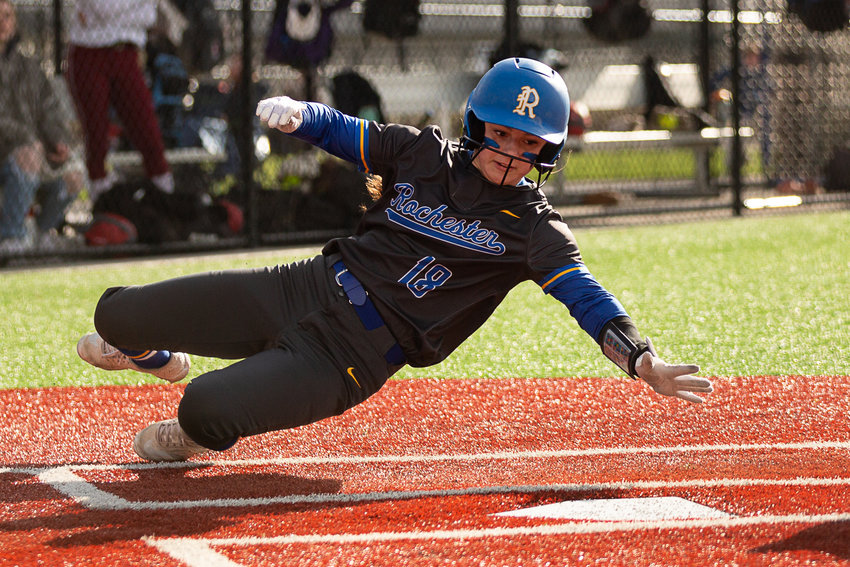 Rochester's Macey Fluetsch slides for home against W.F. West April 12 at Rec Park.