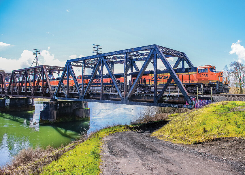 A BNSF freight train passes over the Lewis River near Woodland on a sunny afternoon on Tuesday, April 11.