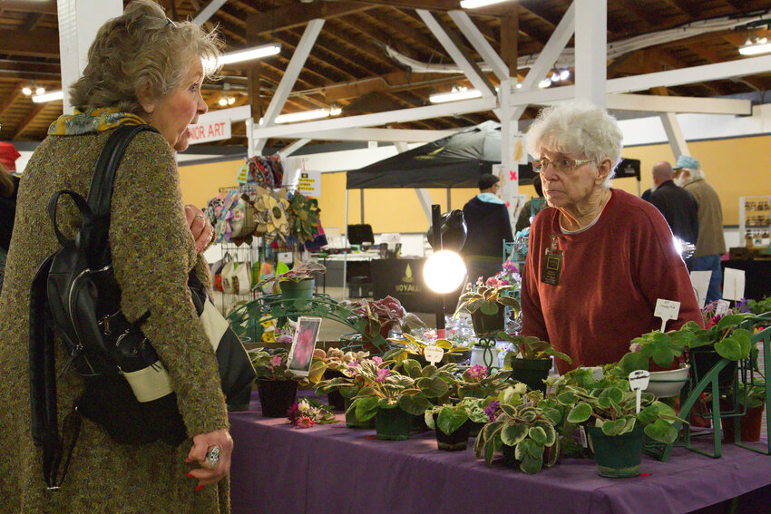 Shirley Swenson, right, of Violets By SJS interacts with a customer during the Spring Vendor Blender at the Southwest Washington Fairgrounds in Chehalis on Saturday.