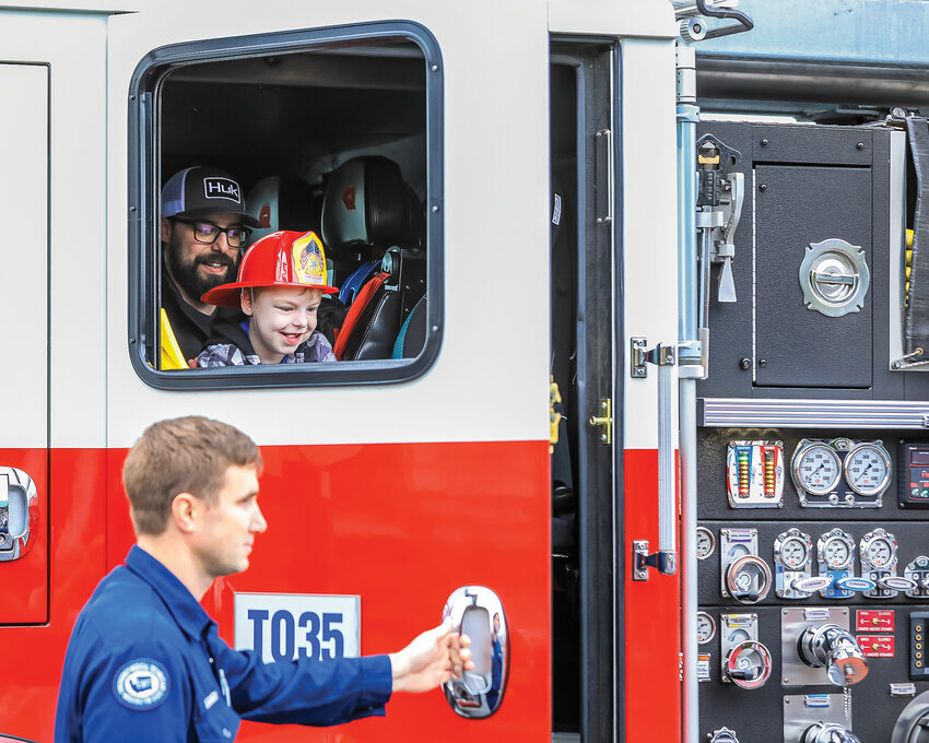Brantleigh Holzman and his father Dylan get out of a fire engine at Rocky&rsquo;s Pizza in Battle Ground for the 6-year-old&rsquo;s wish reveal party on Sunday, April 23.