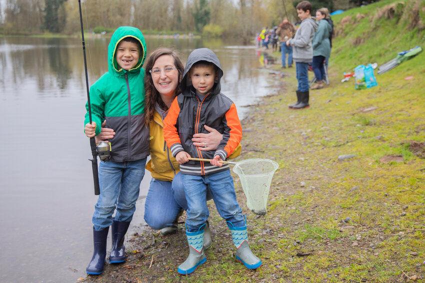Samantha Huang smiles for a photo with Julian, 6, and Talon, 5, during a fishing derby at Fort Borst Park in Centralia on Saturday. The annual derby was hosted by the Centralia Lions Club, which also provided free food and raffle prizes for attendees.