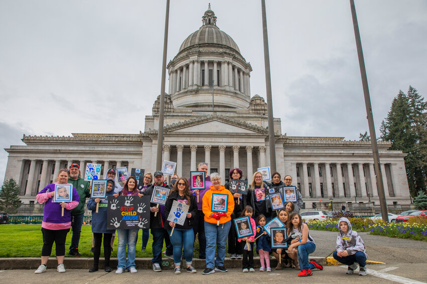 Demonstrators gather outside the Washington State Capitol building in Olympia for Child Abuse Prevention Month during an event organized by the family of Hazel Journey on Sunday, April 23, 2023.