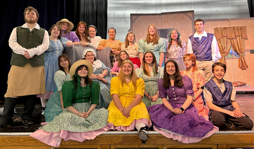 The cast of  &ldquo;Goldi &mdash; The Untold Story&rdquo; poses for a photo with playwright/costumer Elizabeth West and director Doug West on stage at Rochester High School during a rehearsal on Monday, April 24. Giuia Goretti, an Italian foreign exchange student who plays Scarlett Wolfe, is not pictured.