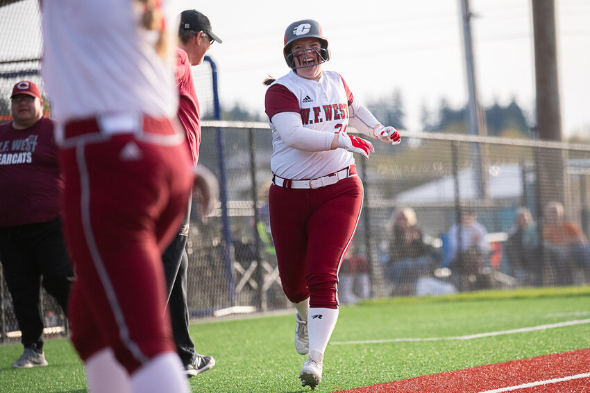 Savannah Hawkins celebrates as she comes to home on her home-run trot after hitting a two-run bomb during W.F. West's 12-2 win over Centralia at Rec Park on April 26.