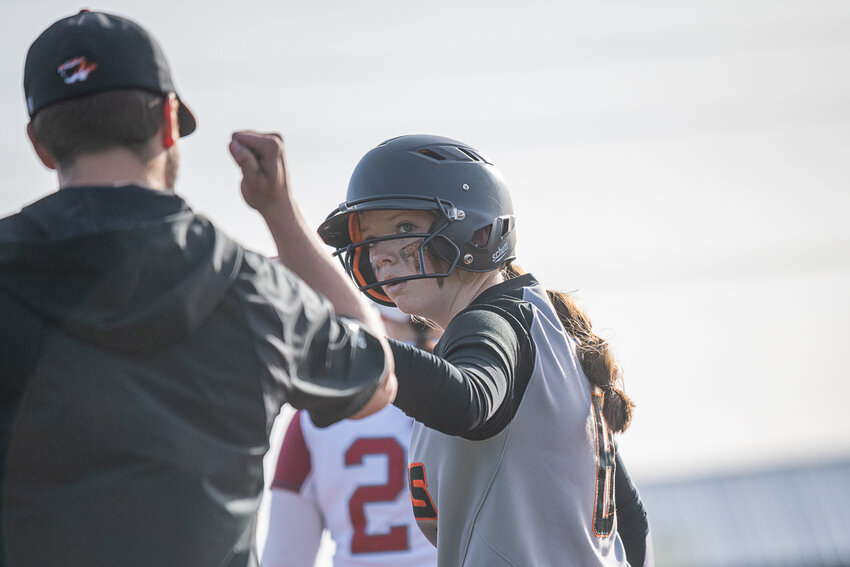 Gracie Schofield fist-bumps her first base coach after hitting a leadoff single in Centralia's 12-2 loss to W.F. West at Rec Park on April 26.