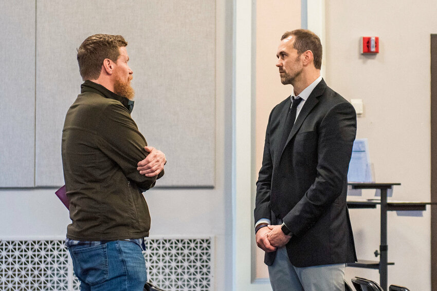 At right, Commissioner Sean Swope approaches Cole Meckle, pastor at Gather Church in Centralia &mdash; which has run the county&rsquo;s coordinated entry program among other services for homelessness &mdash; ahead of an October 2022 meeting in the Lewis County commissioners&rsquo; hearing room in Chehalis.