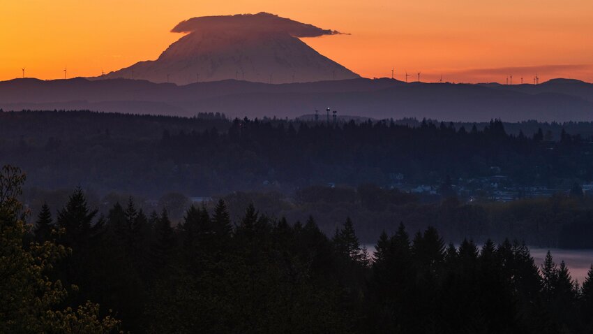 A lenticular cloud forms over Mount Rainier at sunrise beyond Chehalis on Saturday, April 29, 2023.