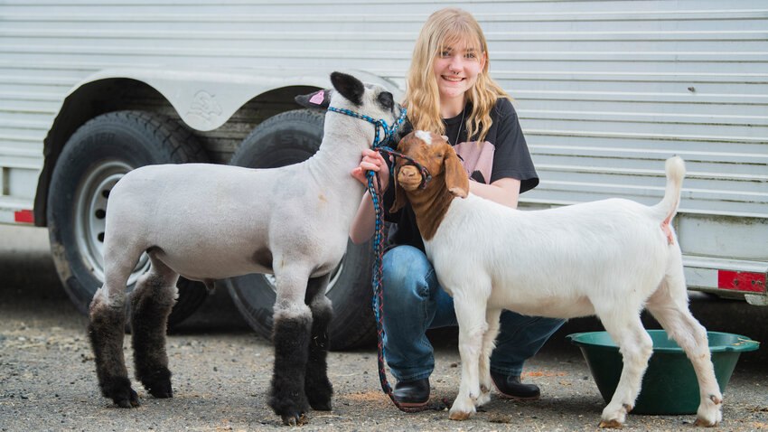 Madison Keller, 16, smiles for a photo with her sheep Romeo and goat Jellybean during the Spring Youth Fair on Sunday at the Southwest Washington Fairgrounds.