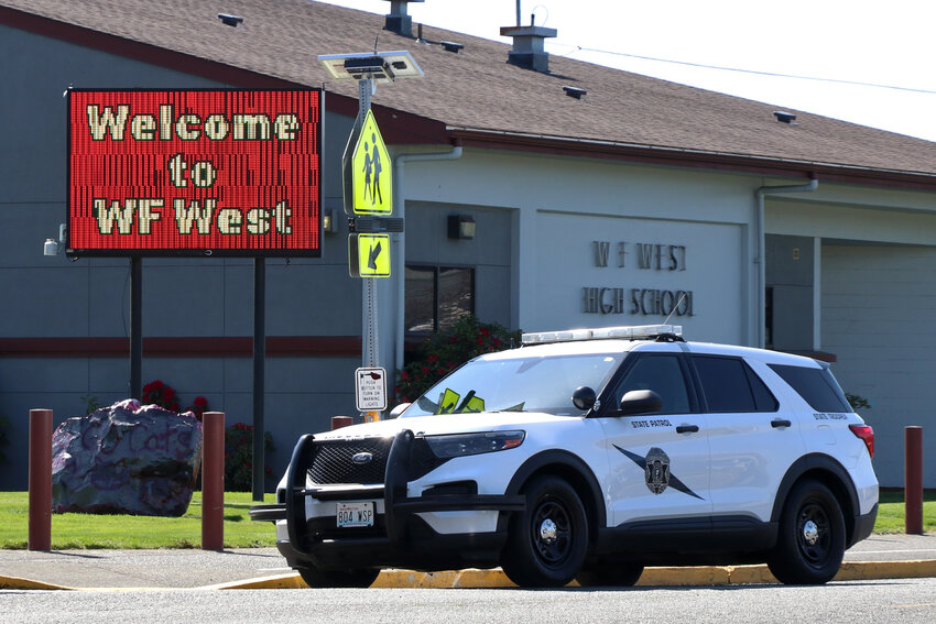 A Washington State Patrol vehicle is parked in front of W.F. West High School on Thursday during a lockdown.