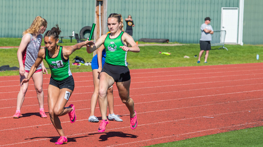 Tumwater sophomores Ava Jones and Reese Heryford participate in a relay during a track meet at Tiger Stadium in Centralia on Friday, May 12.