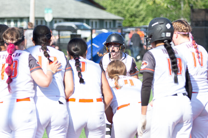 Centralia's Lauren Wasson (center) yells after hitting a solo home run against R.A. Long in the 2A District 4 quarterfinals at Rec Park May 18.