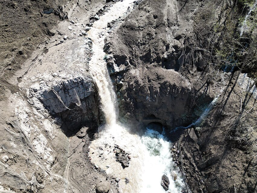 The slide washed out an 85-foot bridge, damaged the roadway and severed power to the observatory.