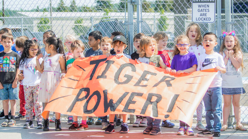 Elementary school students in Centralia hold up a &ldquo;Tiger Power&rdquo; sign for the state-bound high school softball team on Thursday morning.