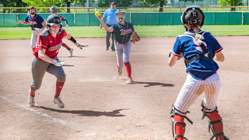 Pe Ell-Willapa Valley pitcher Lauren Emery throws a baserunner out at home plate during a game against Okanogan at Kiwanis Park in Yakima on Friday, May 26.