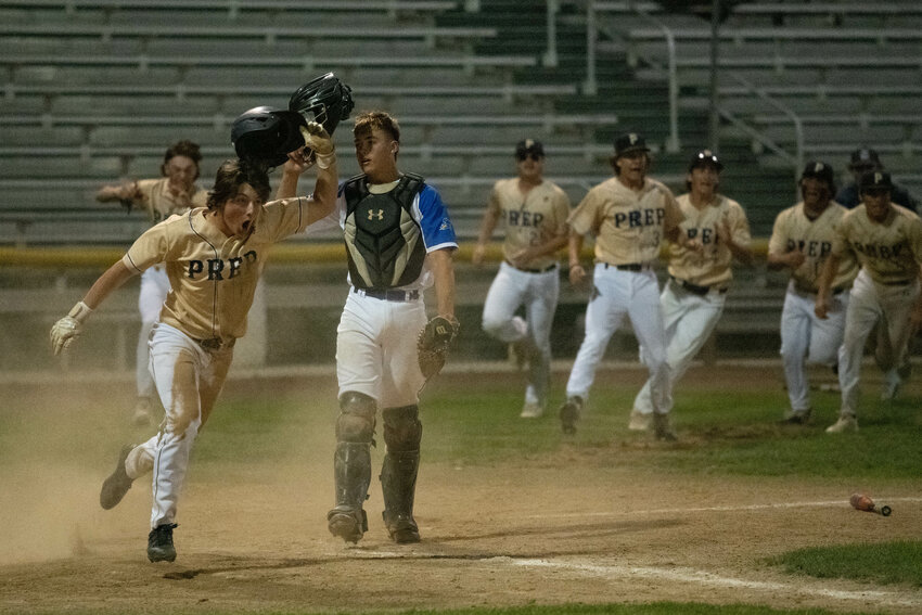 Tri-Cities Prep's Henry Douglas celebrates in front of Adna's Asher Guerrero after celebrating the winning run in TCP's 5-4 win over the Pirates in the 2B state title game on May 27 at Parker Feller Field in Yakima.