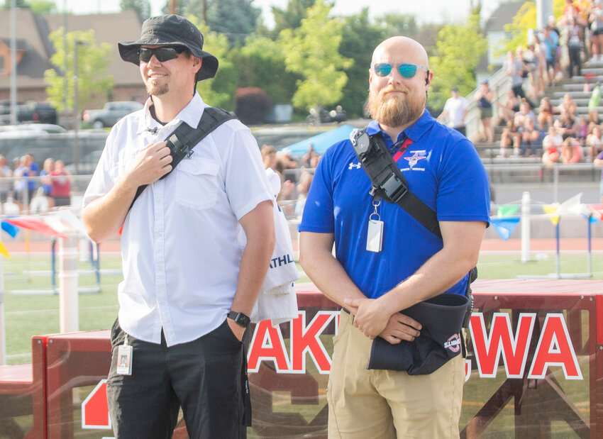 Trainers Josh Holliday and Joel Buffum receive a standing ovation from the crowd at Zaepfel Stadium at Eisenhower High School in Yakima Friday after providing life-saving treatment for Napavine&rsquo;s Maddie Dickinson.