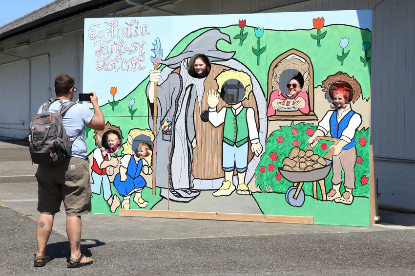 Attendees of the Centralia Fantasy Festival pose for a photo in a photo booth cutout for the festival at the Southwest Washington Fairgrounds on Saturday, May 27, 2023.